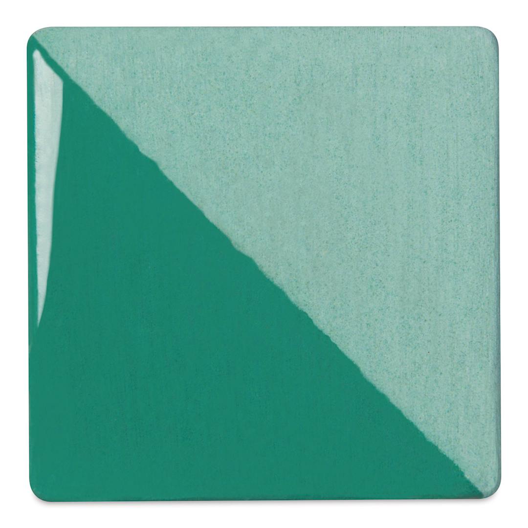 Open in modal - Speedball Ceramic Underglaze - Aqua, Opaque, fired on white clay bisque tiles, half covered in Speedball Clear Glaze, fired to cone 05