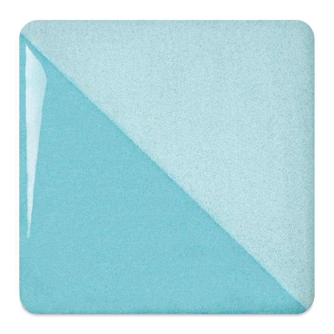 Open in modal - Speedball Ceramic Underglaze - Robin's Egg, fired on white clay bisque tiles, half covered in Speedball Clear Glaze, fired to cone 05