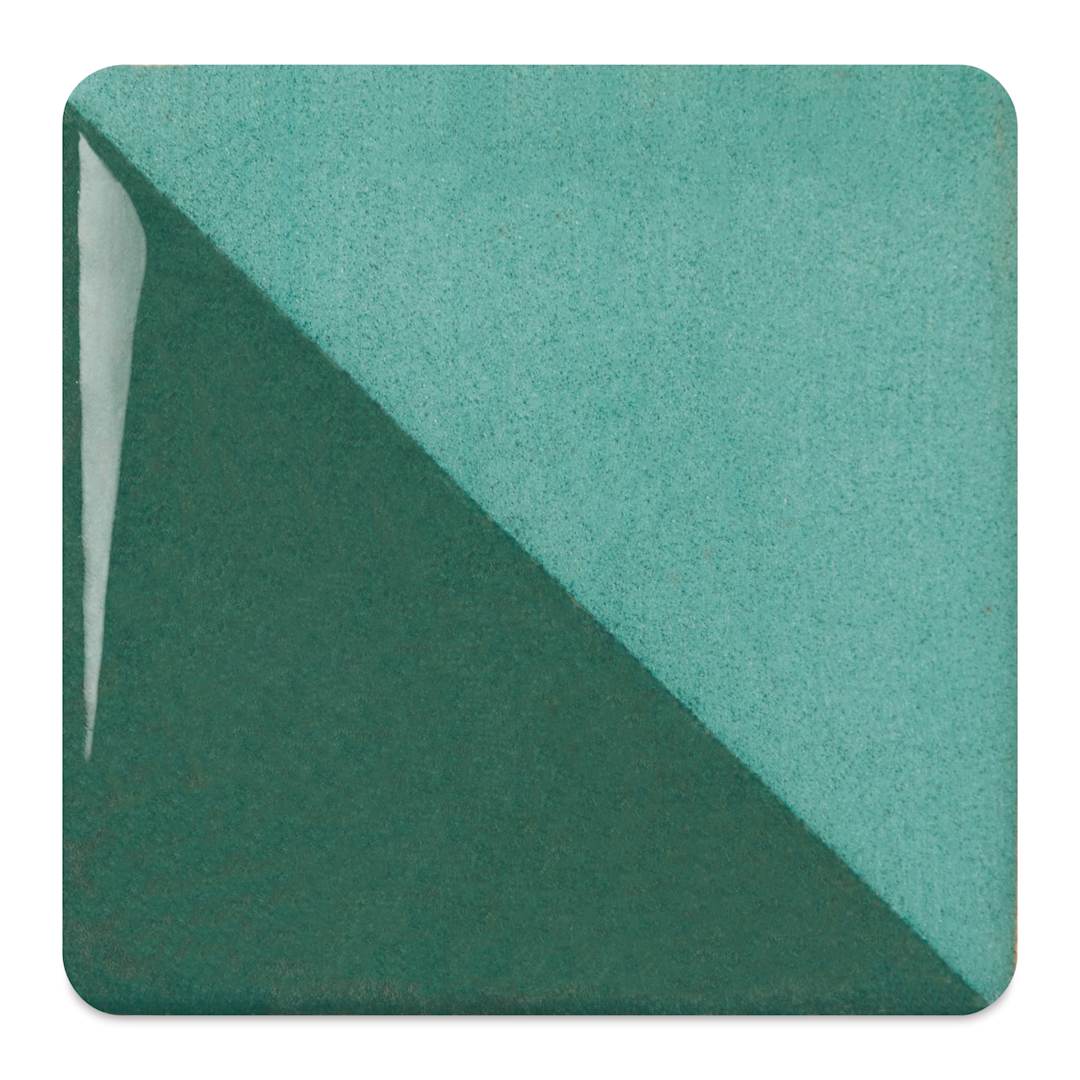 Open in modal - Speedball Ceramic Underglaze - Emerald, fired on white clay bisque tiles, half covered in Speedball Clear Glaze, fired to cone 05