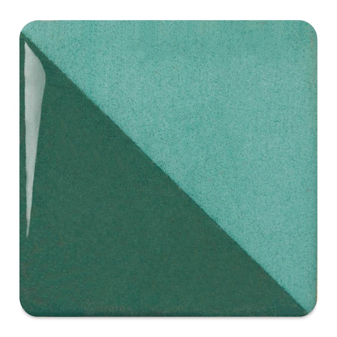 Open in modal - Speedball Ceramic Underglaze - Emerald, fired on white clay bisque tiles, half covered in Speedball Clear Glaze, fired to cone 05