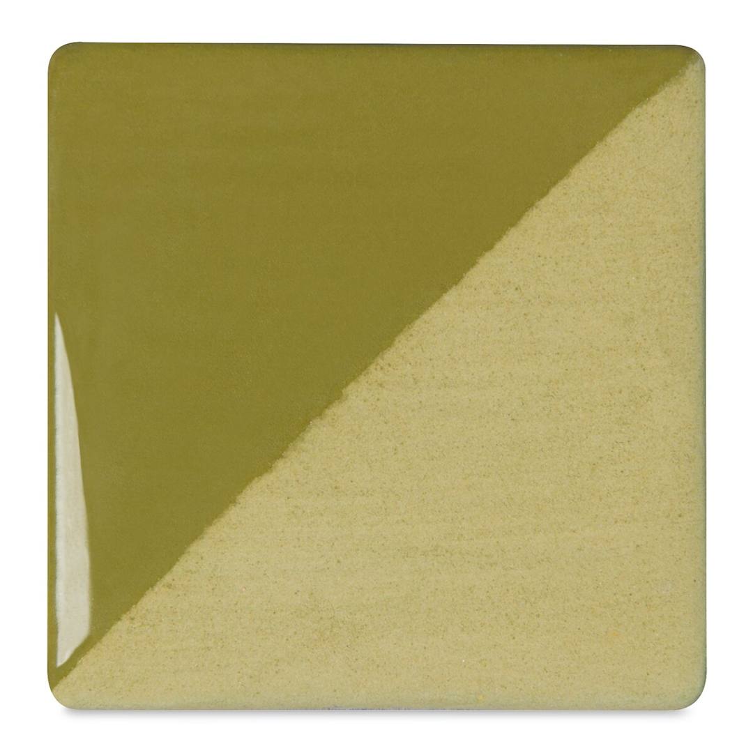 Open in modal - Speedball Ceramic Underglaze - Avocado, Opaque, fired on white clay bisque tiles, half covered in Speedball Clear Glaze, fired to cone 05