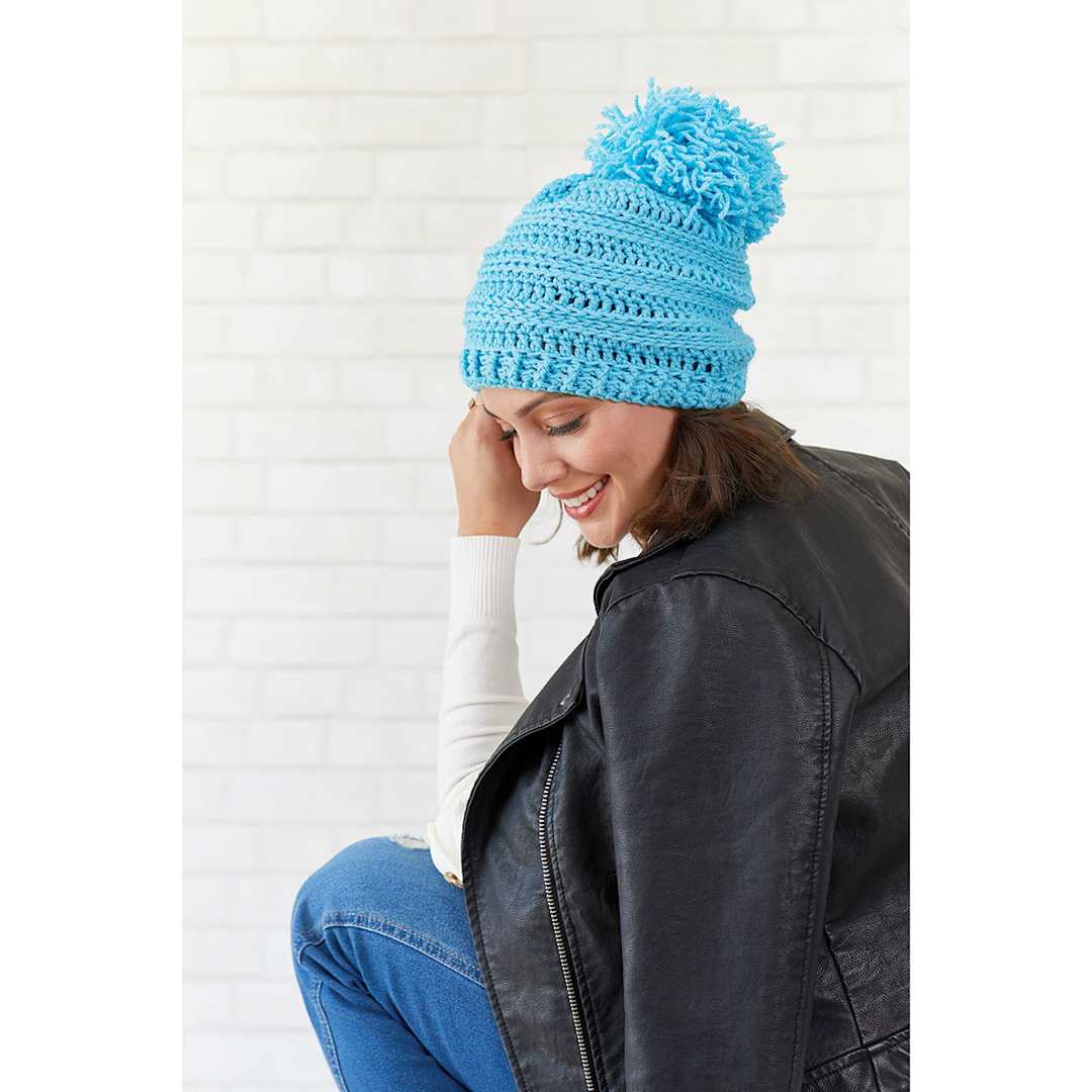 Open in modal - Red Heart Heat Wave Yarn - Model wearing stocking cap made with Blue Skies Yarn