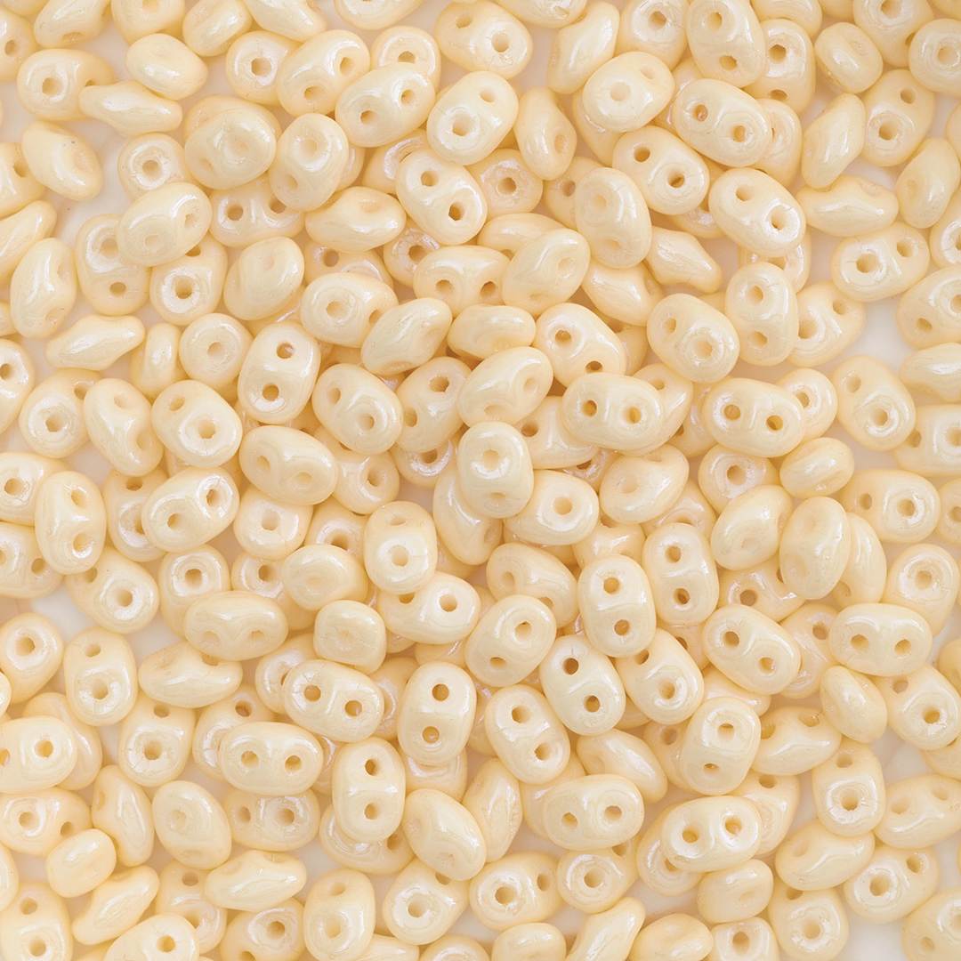 Open in modal - John Bead Czech Glass SuperDuo Two-Hole Beads - Pile of Champagne beads shown