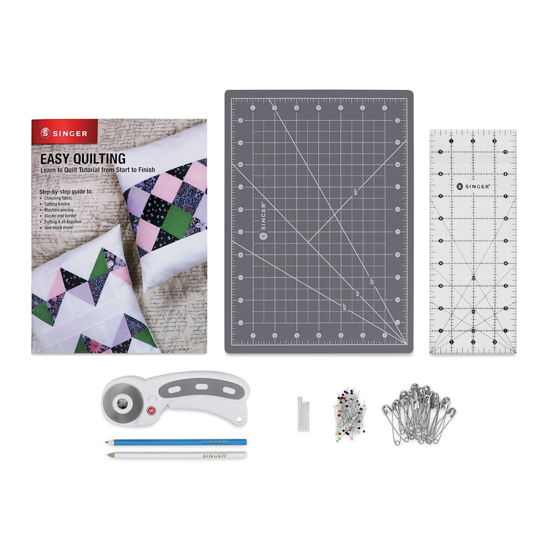 Open in modal - Singer Learn to Quilt Starter Kit, contents laid out next to step-by-step guide