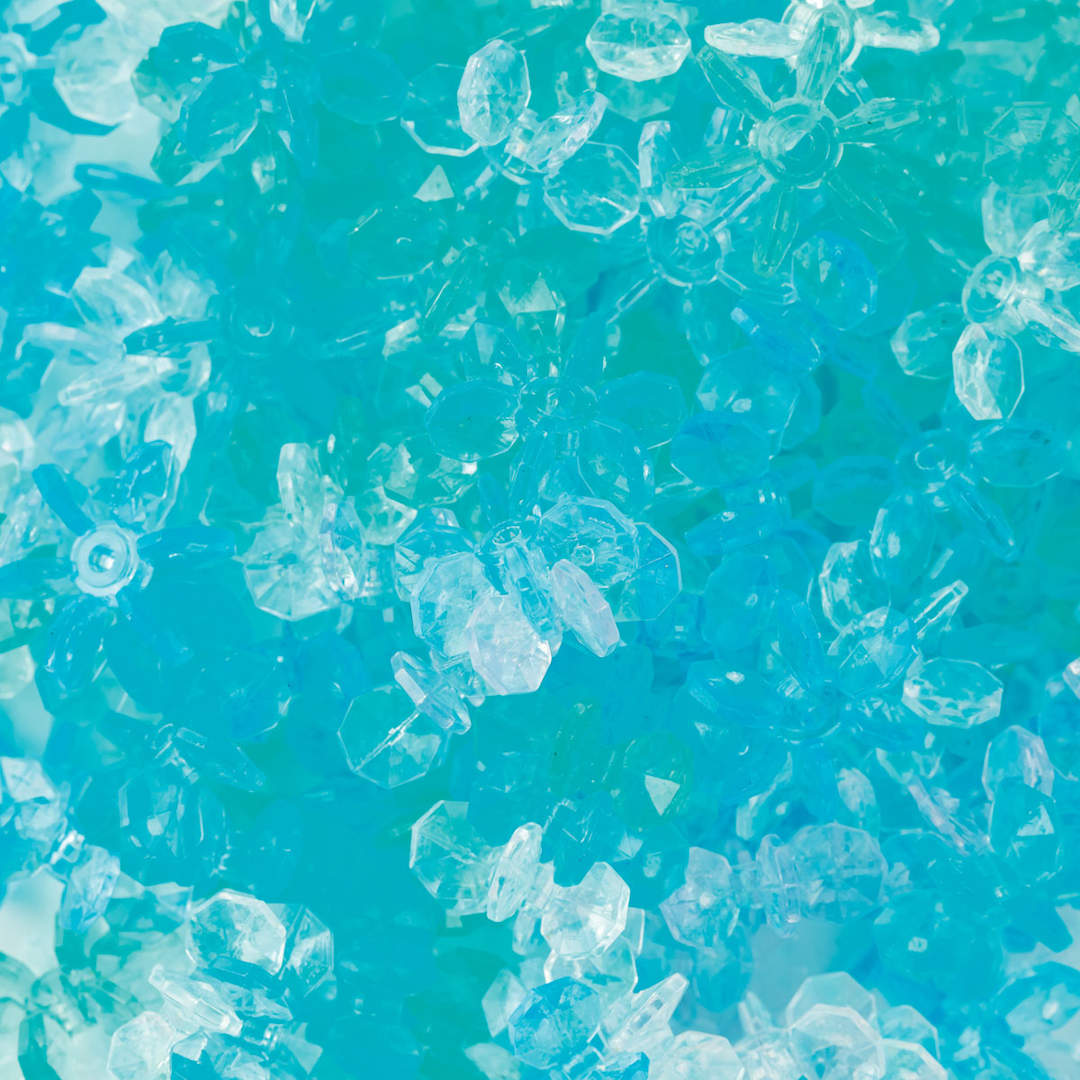 Open in modal - Essentials by Leisure Arts Snowflake Beads - Ice, Transparent, 18 mm, Package of 200 (Close-up of beads)