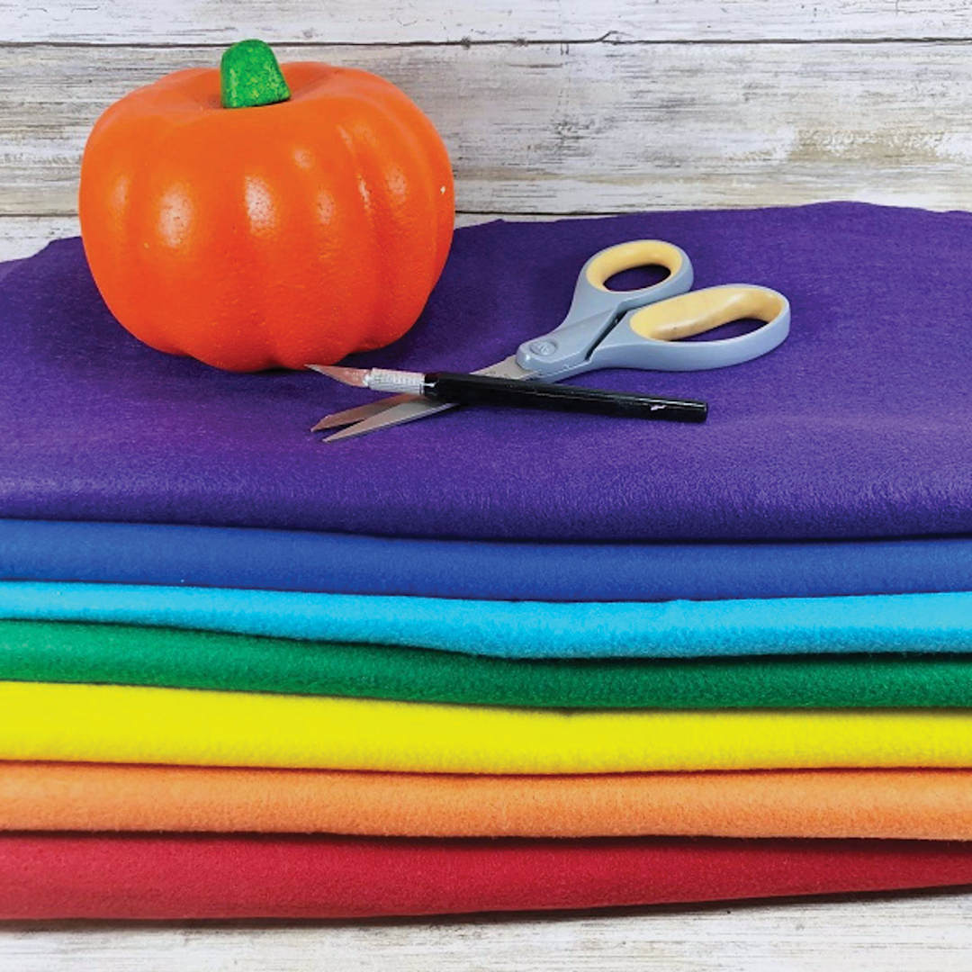 Open in modal - Kunin Classic Felt - Assorted colors of felt folded with scissors, knife, and pumpkin