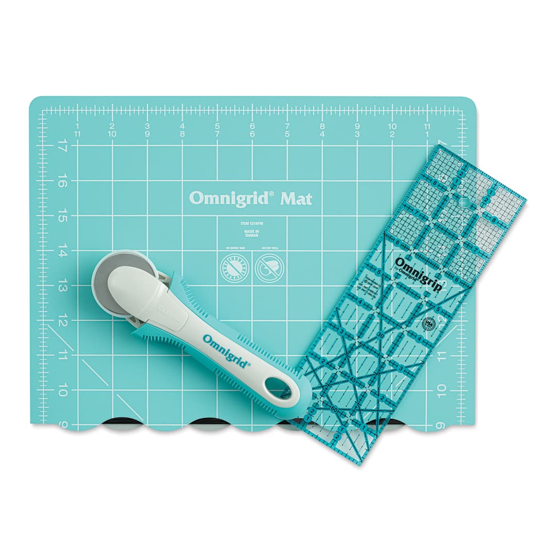 Open in modal - Rotary cutter with small folded mat and ruler laid out