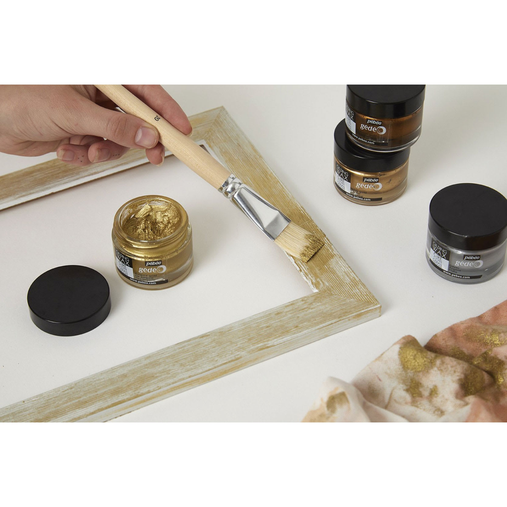 Pebeo Gedeo Gilding Waxes being applied to a frame with a brush.
