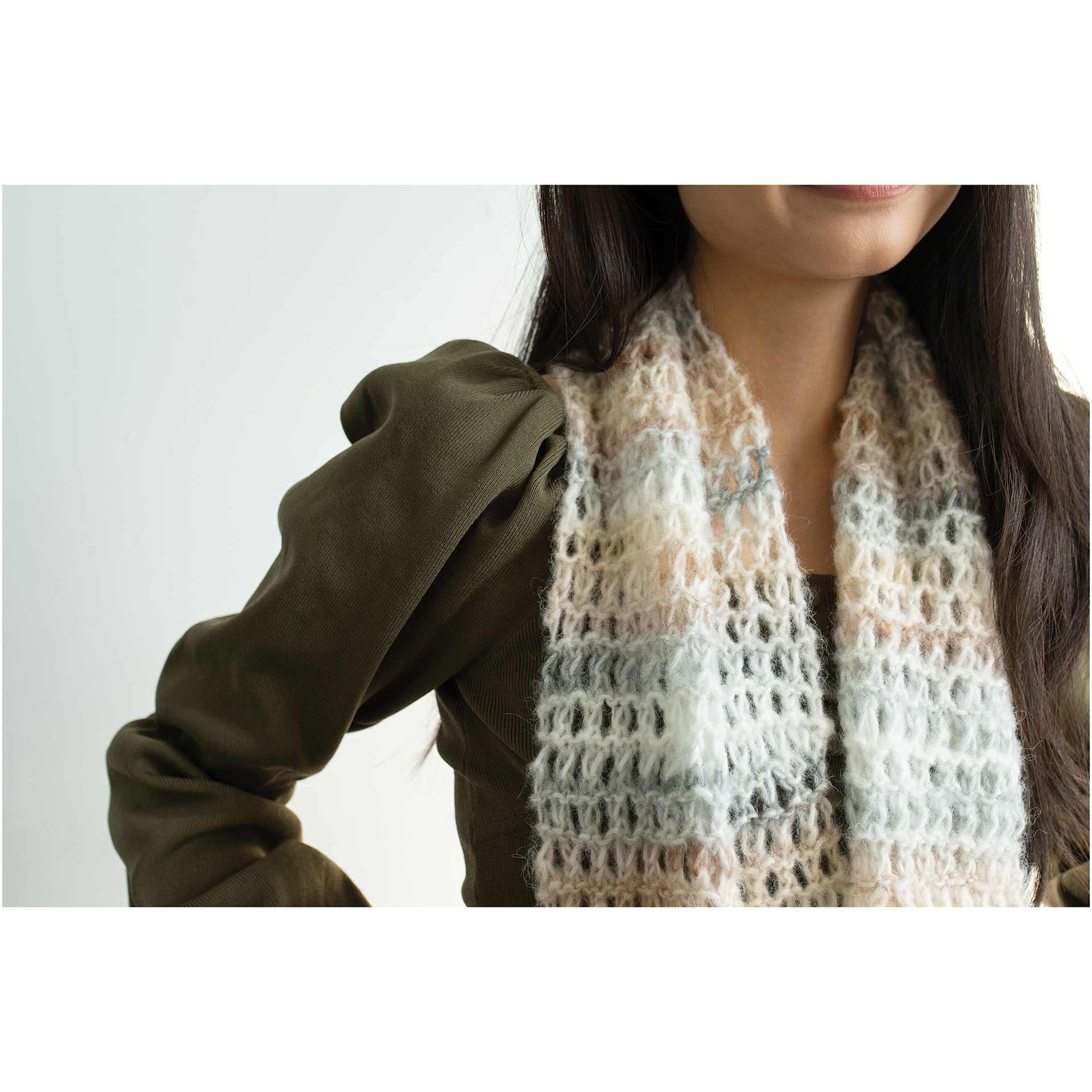 Lion Brand Scarfie Lite Yarn, adult wearing a scarf around neck made of yarn