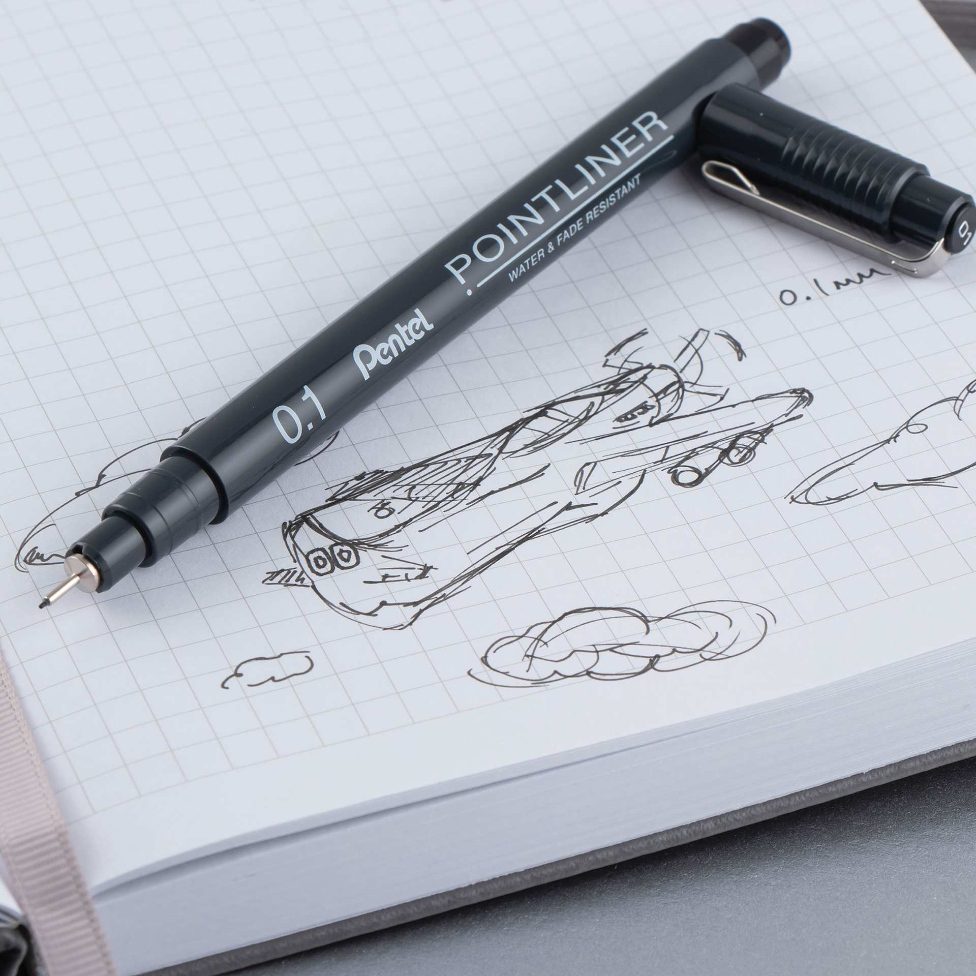 Pentel Arts Pointliner Pen - Black, 0.1 mm (being used to draw an airplane)