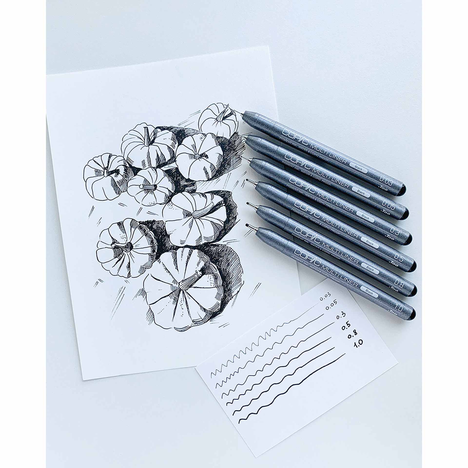 Copic Multiliner Pens, six pens on top of drawing and example of the line width