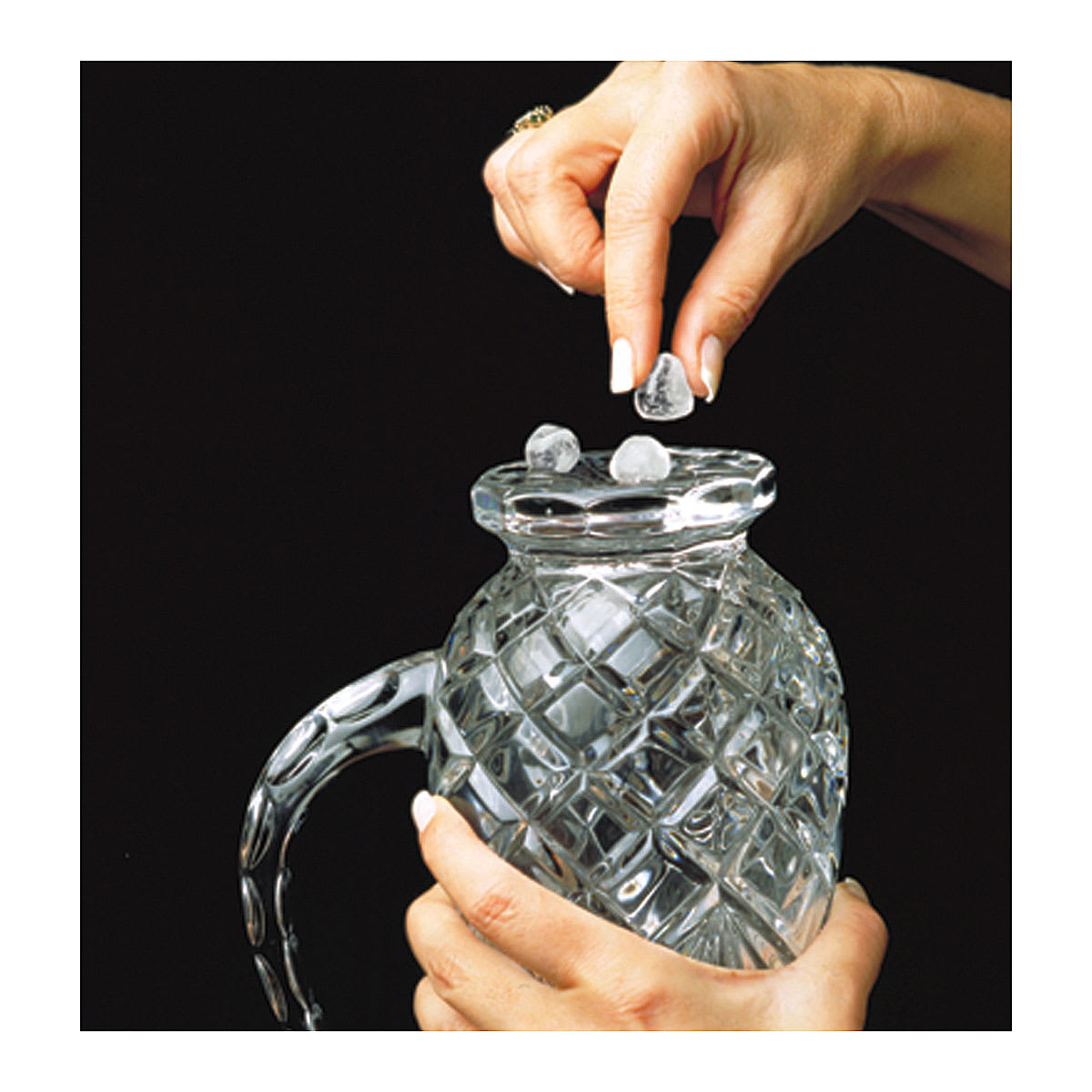 Clear Museum Gel - hands attaching gel balls to bottom of glass pitcher