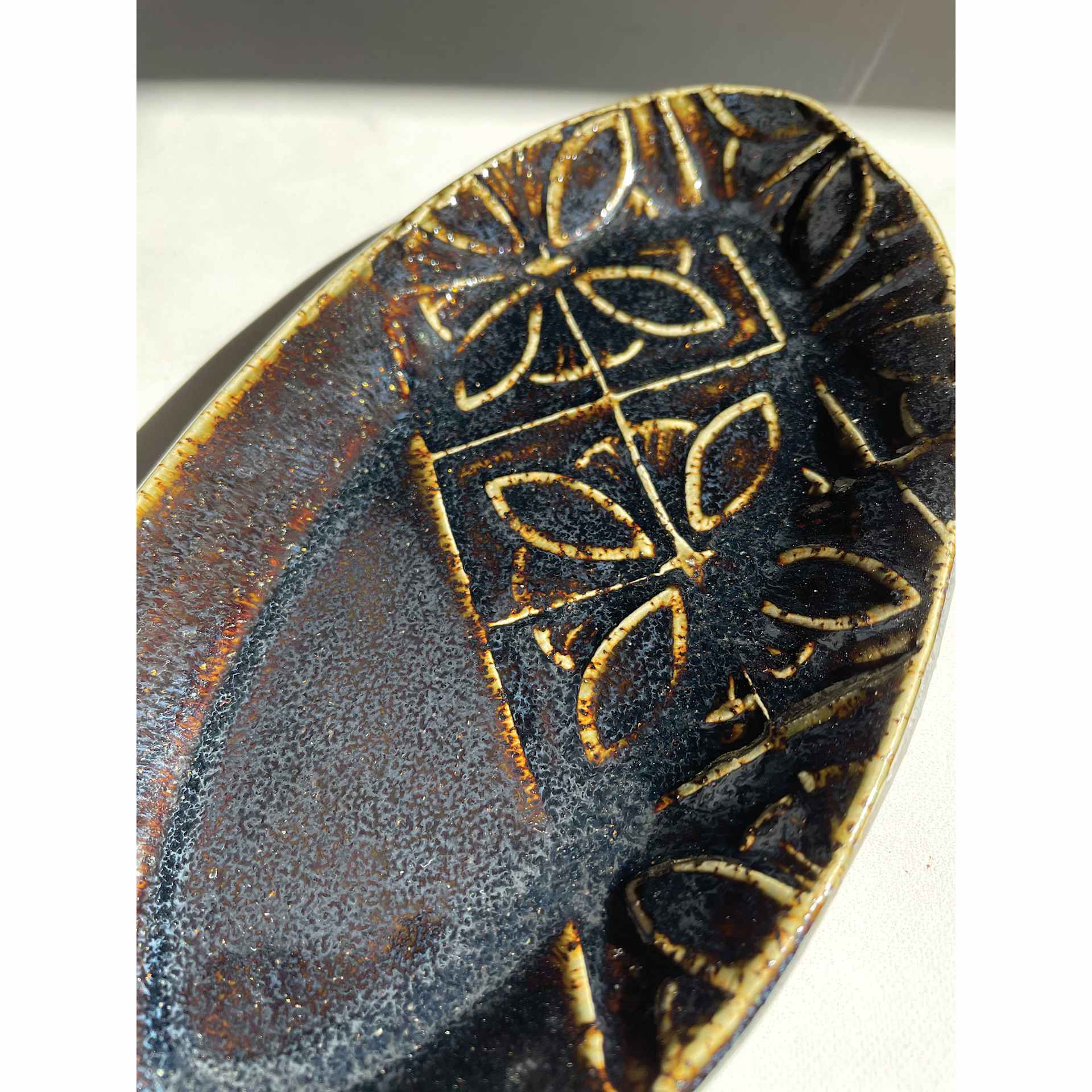 Cosmic Oilspot Amaco Potter's Choice Glaze applied to a plate.
