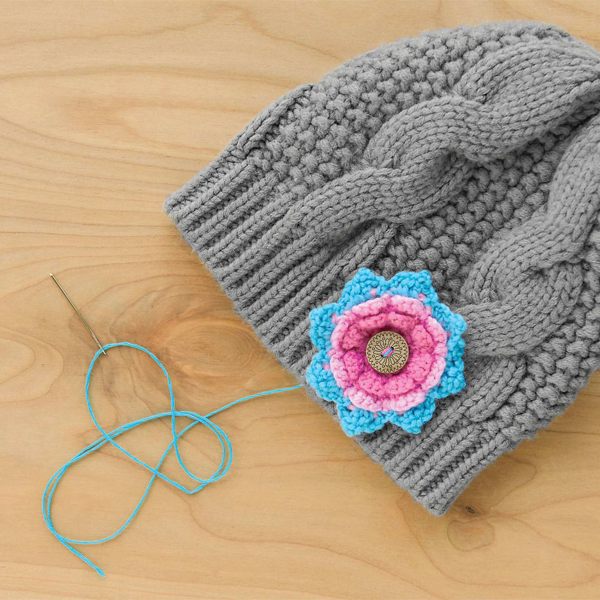 Boye Wood Container & Yarn Needles - Pkg of 6 Needles, Coral Lid - in use, next to knit beanie example