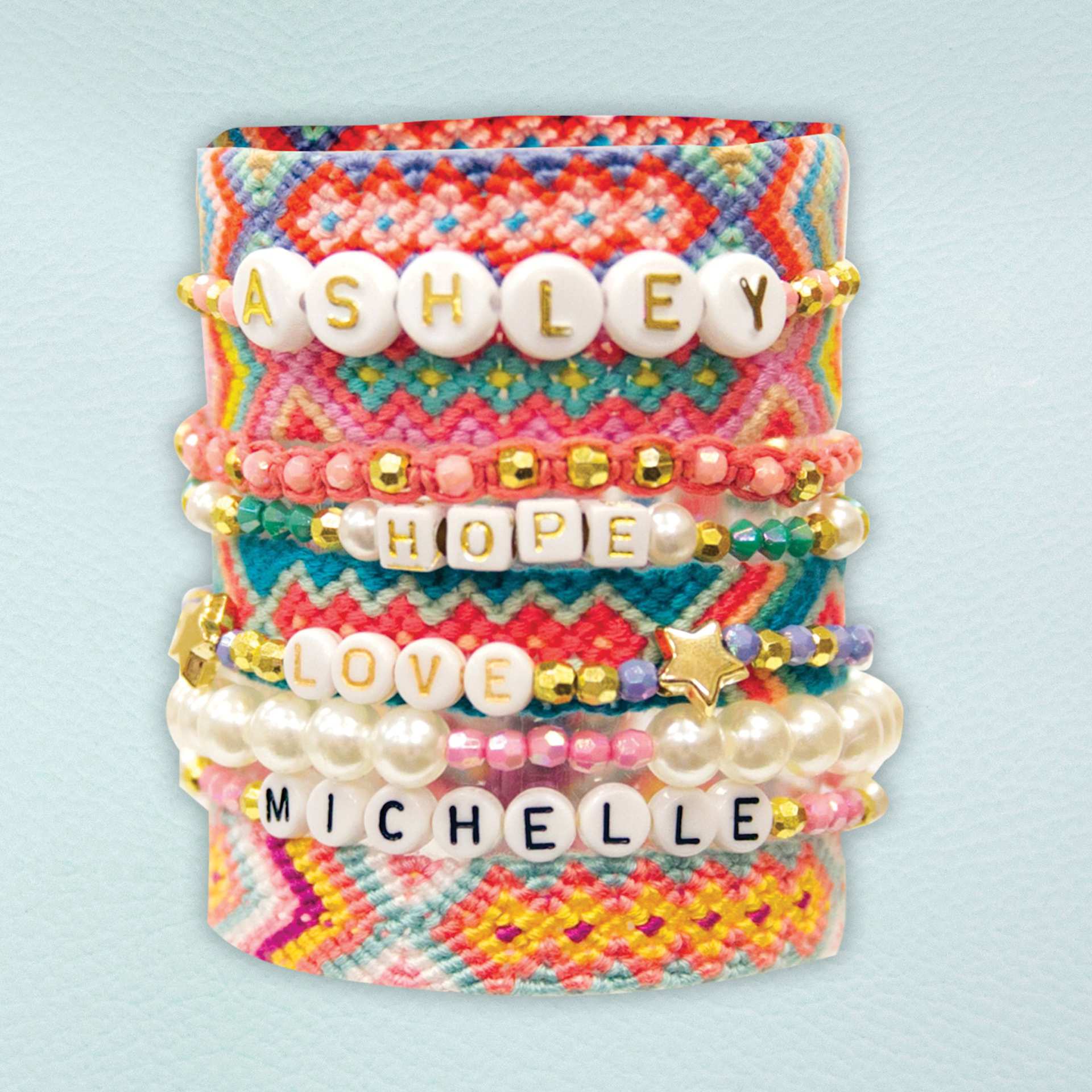 STMT DIY Custom Jewelry Kit and Case - Several finished bracelets made with the kit shown stacked