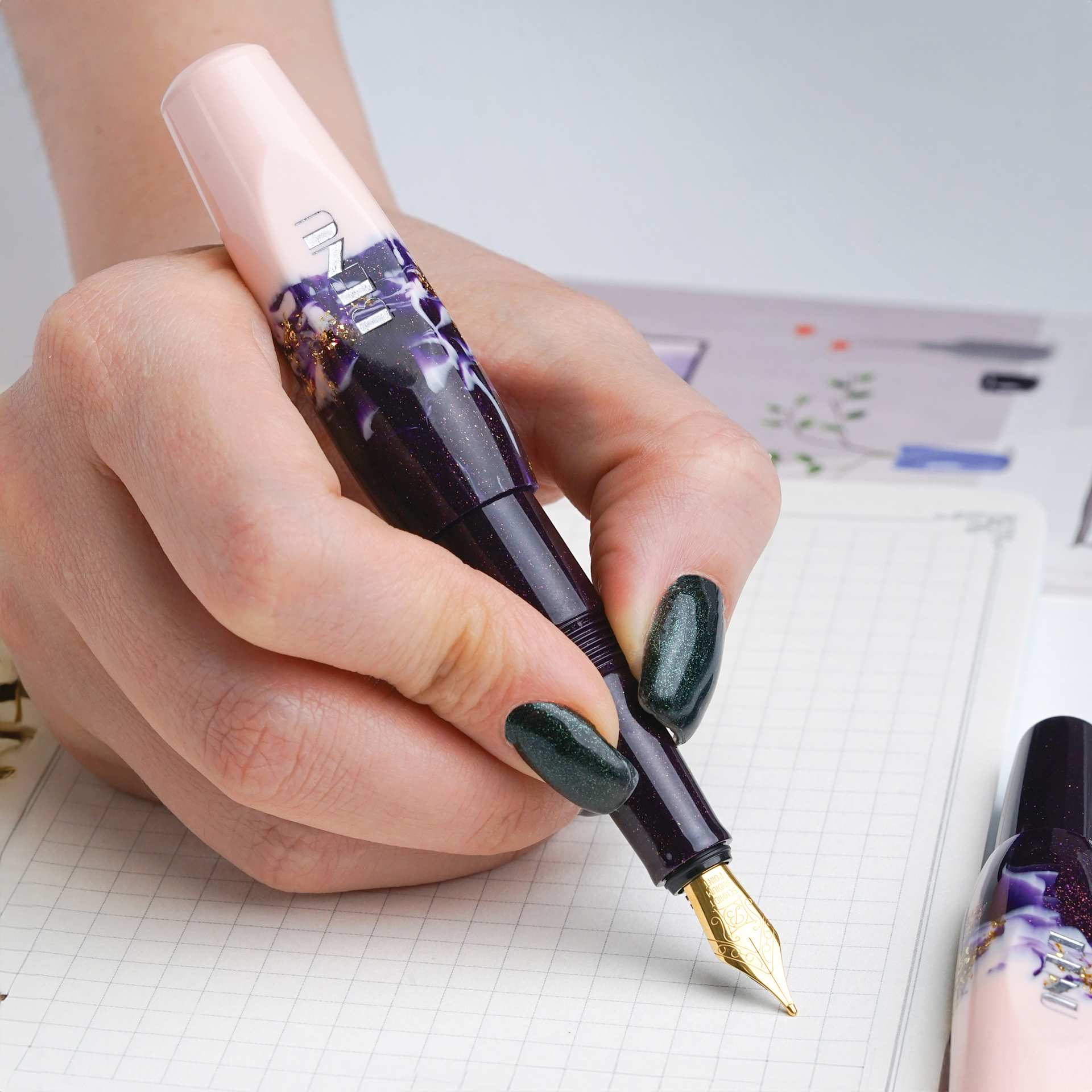 Benu Pixie Fountain Pen - Plum Cream, pen in hand (image may show a different size nib)
