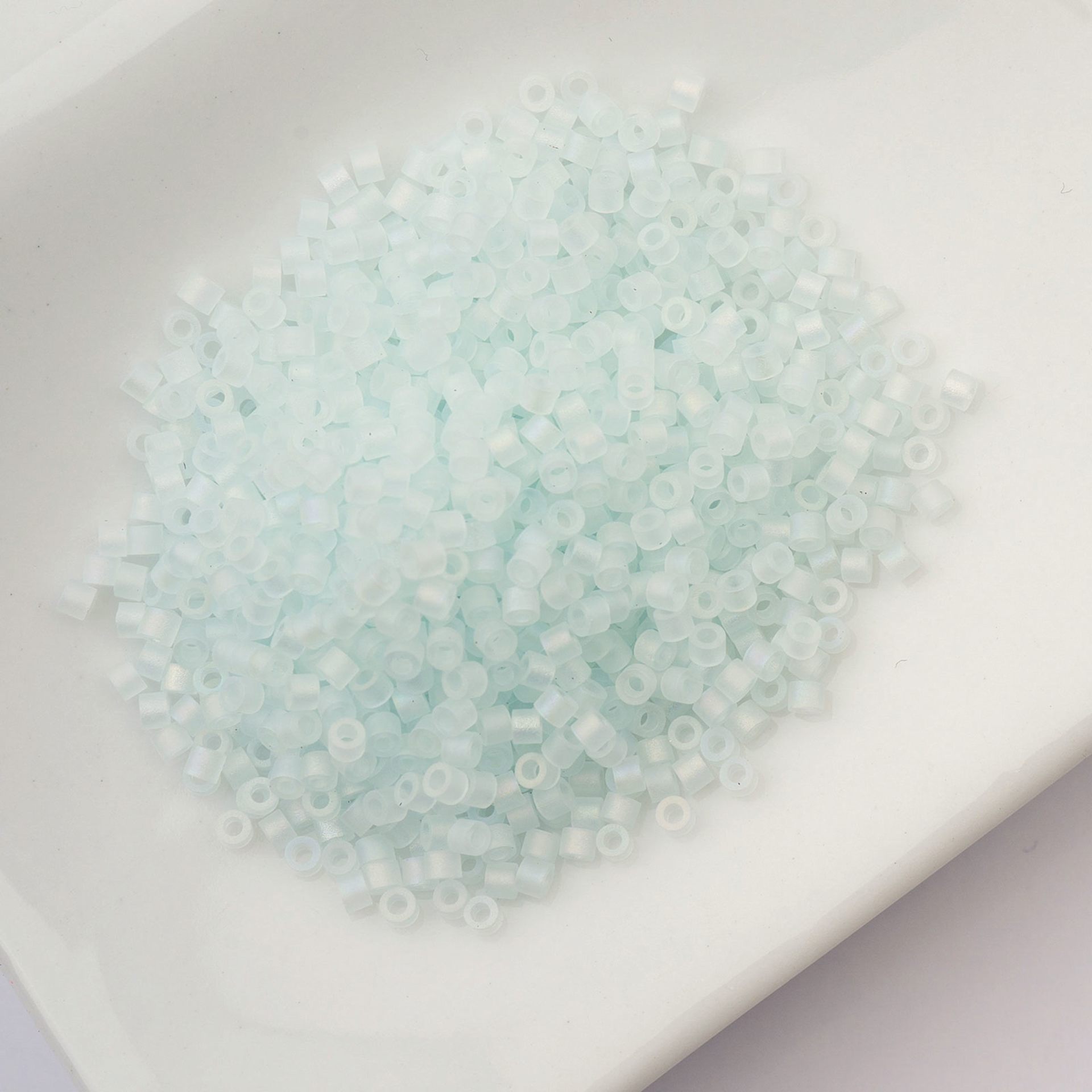 John Bead Cylin 11/0 Matte Macaron Cylindrical Seed Beads - Soft Blue AB sitting in dish