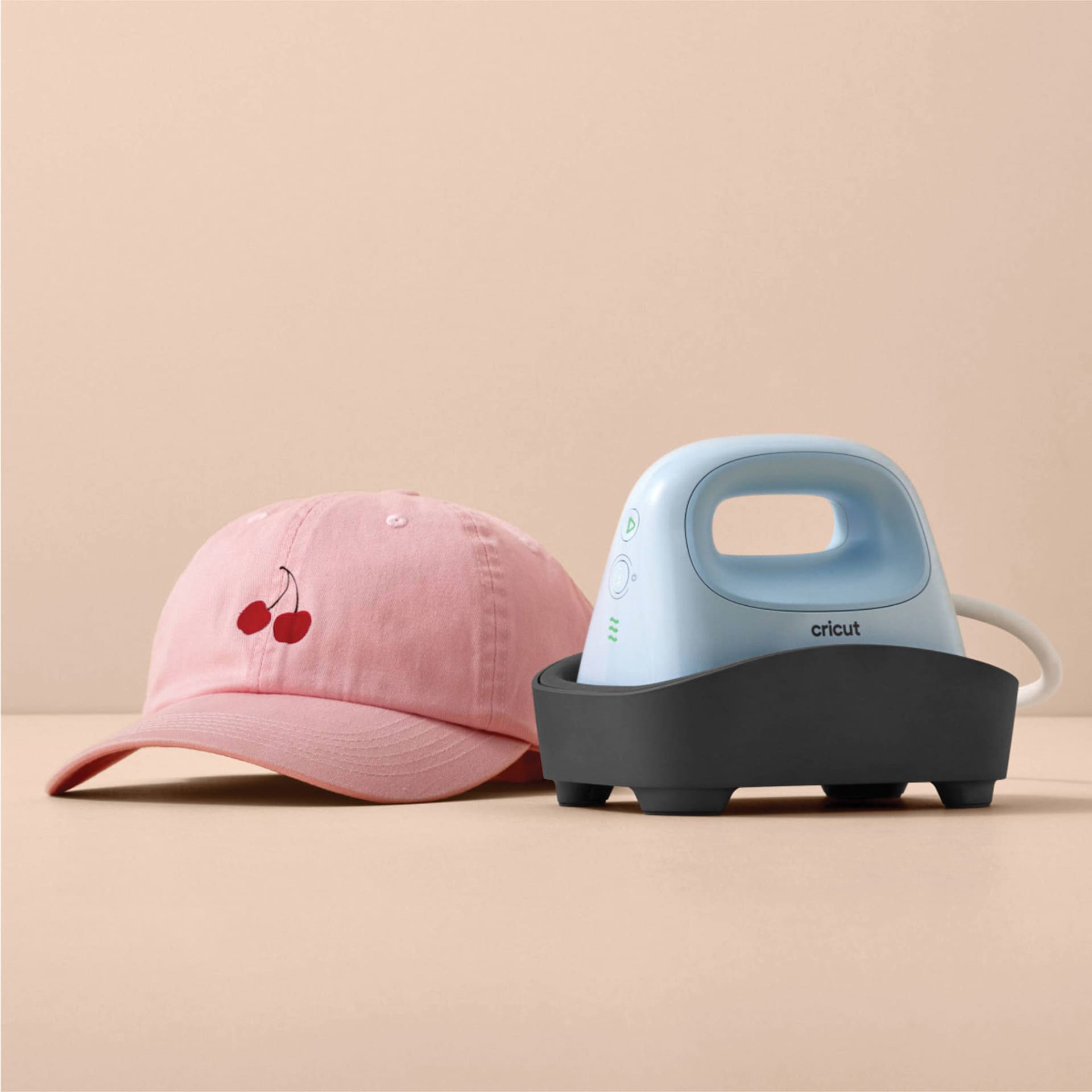 Cricut Hat Press (finished cap next to the press and stand)