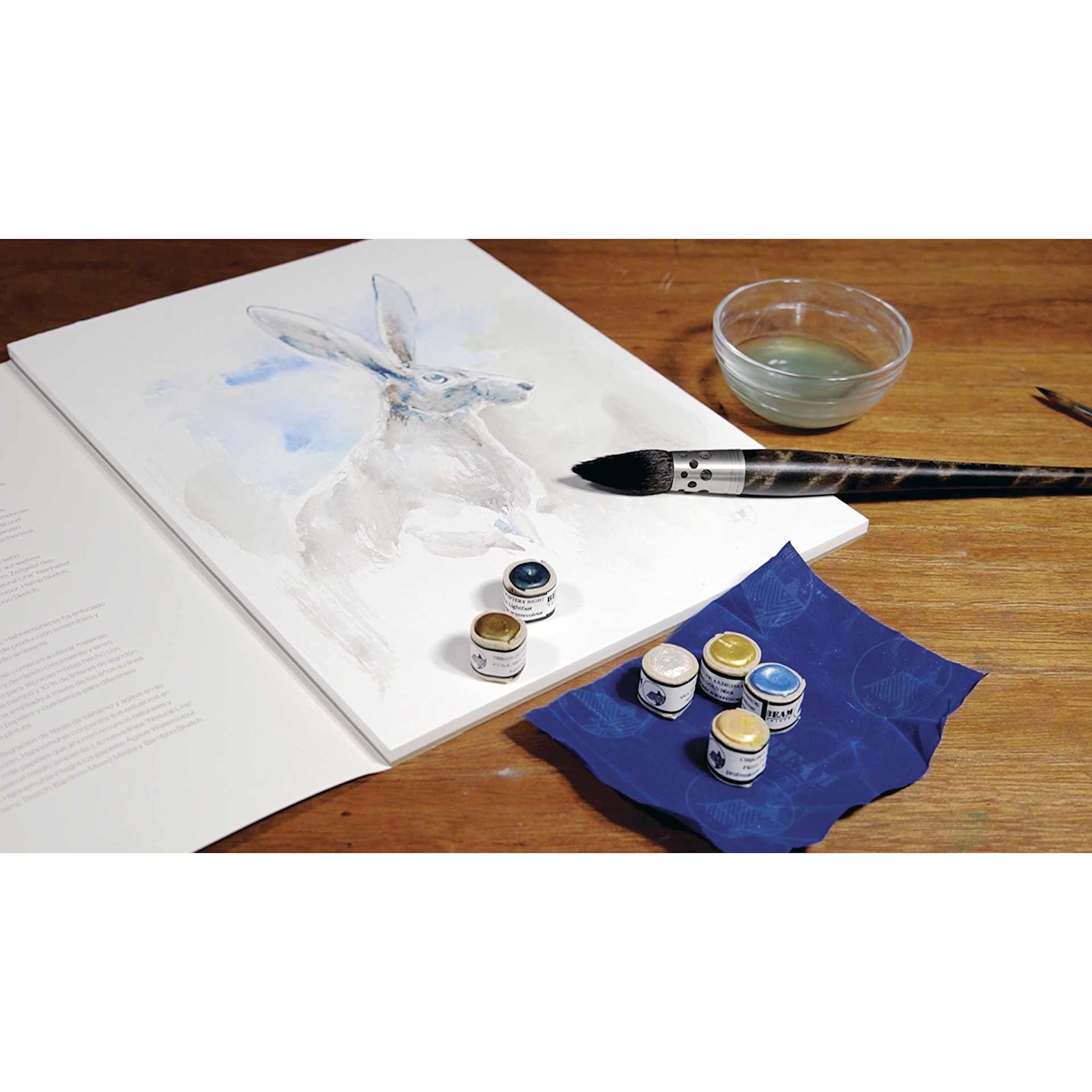 Beam Paints Watercolor Paintstones, with other art supplies on desk