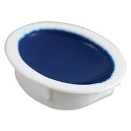 Close up of individual oval pan of blue watercolor.