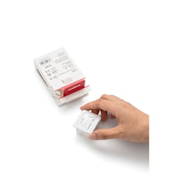 A hand holding a refill cup.