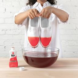 Rit All Purpose Liquid Dye - Coral, 8 oz, submerging shoes in dyed water