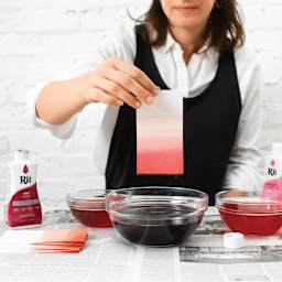 Rit All Purpose Liquid Dye - Wine, 8 oz, dipping paper in dyed water