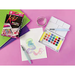 Koi Creative Art Colors Sketch Watercolor Set - Set of 24 w/Brush box and open set beside painting of jellyfish