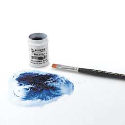 Brusho Crystal Colours - Open Prussian Blue tub with brush next to paper showing swirl of blue