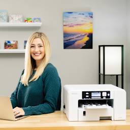 Sawgrass Sublimation Printer - SG500 (person using laptop to send design to printer)