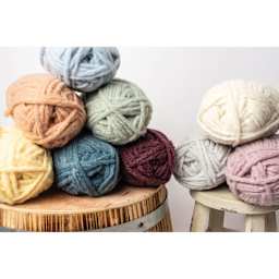 Lion Brand Feels Like Butta Thick & Quick Yarn, skeins on to of each other