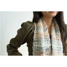 Lion Brand Scarfie Lite Yarn, adult wearing a scarf around neck made of yarn