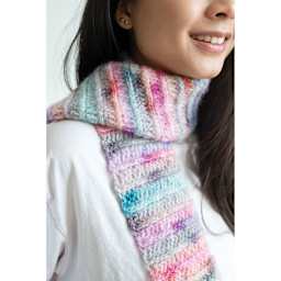 Lion Brand Scarfie Lite Yarn, adult wearing a colorful scarf made of yarn