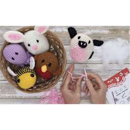 Leisure Arts Crochet Pudgies Kits - finished examples in basket and example in progress