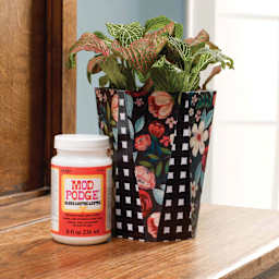 Floral pattern paper adhered to plant pot and sealed with Plaid Mod Podge Gloss Finish