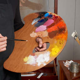 Painter holding Grand View Confidant style in left hand, with paint