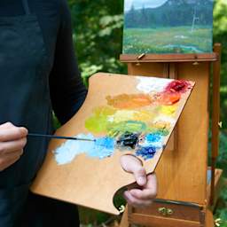 Painter holding Highland Style palette, with paints