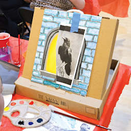 Front of Toss Art Locker Portable Easel holding artwork.