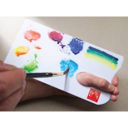 Caran d'Ache Palette Aquarelle (person using a brush on the palette)