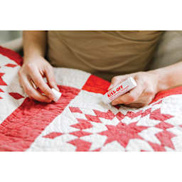 Kiss-Off Stain Remover, in hand removing stain from quilt