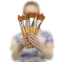 Model holding several Blick Mega Golden Taklon Brushes in fan