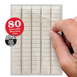 StikkiWorks StikkiTack Adhesive Putty - Pkg of 80, hand peeling off the protective cover from the tacks.