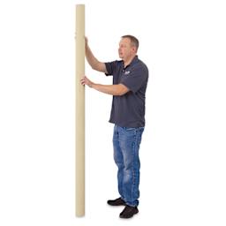 Blick Unprimed Cotton Canvas - Medium Weight, Medium-Smooth Texture, 84" x 10 yds, man standing next to canvas