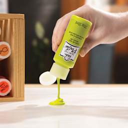 FolkArt Paints for Plastic being poured onto a surface.