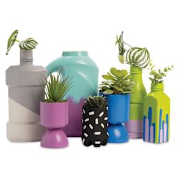 Upcycled bottles painted with FolkArt Paints for Plastics.