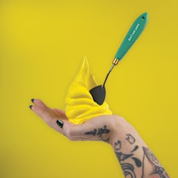 Gaffrey Heavy Body Texture Acrylic Paint in a hand holding a stif peak and a palette knife