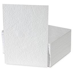 Shizen Professional Watercolor Paper - 100 Cold Press/Rough Sheets, one vertical in front, showing texture