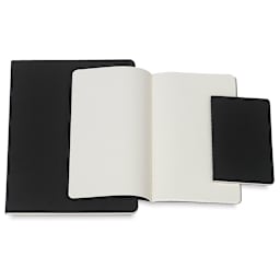 Moleskine Cahier Journals - Assorted sizes of Black Journals shown with one open
