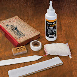 Lineco Book Repair Kit - Components of kit shown with book on table
