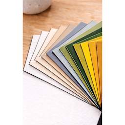 Crescent Berkeley Black Core Matboards, a selection of colors fanned out on tabletop.